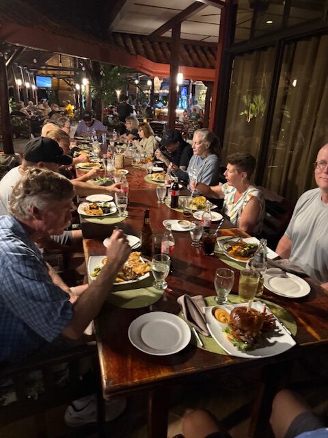 Happy campers from our August 2025 tour, enjoying dinner at Dominical Beach during the Combination Tour.