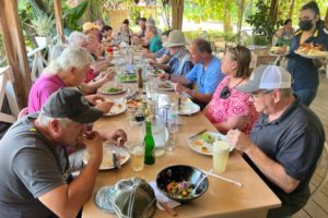 Happy campers eating a mouth-watering lunch consisting of chicken cooked over coffee branches, pizza and more. The lunch was at La Fogata restaurant near Dominical beach.